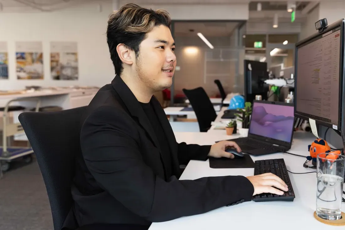 Student Jae Bin Lee on a computer at his internship at Cannon Design.